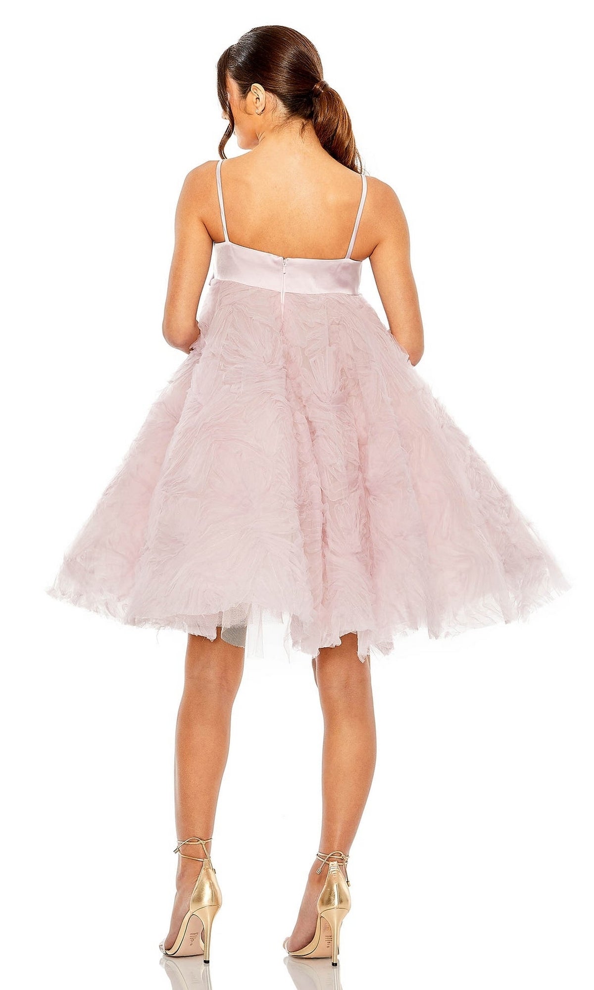 A woman wears the Mac Duggal Short Homecoming Dress 20583 in rose pink with a flared, knee-length skirt and gold high heels, photographed from behind against a white background.